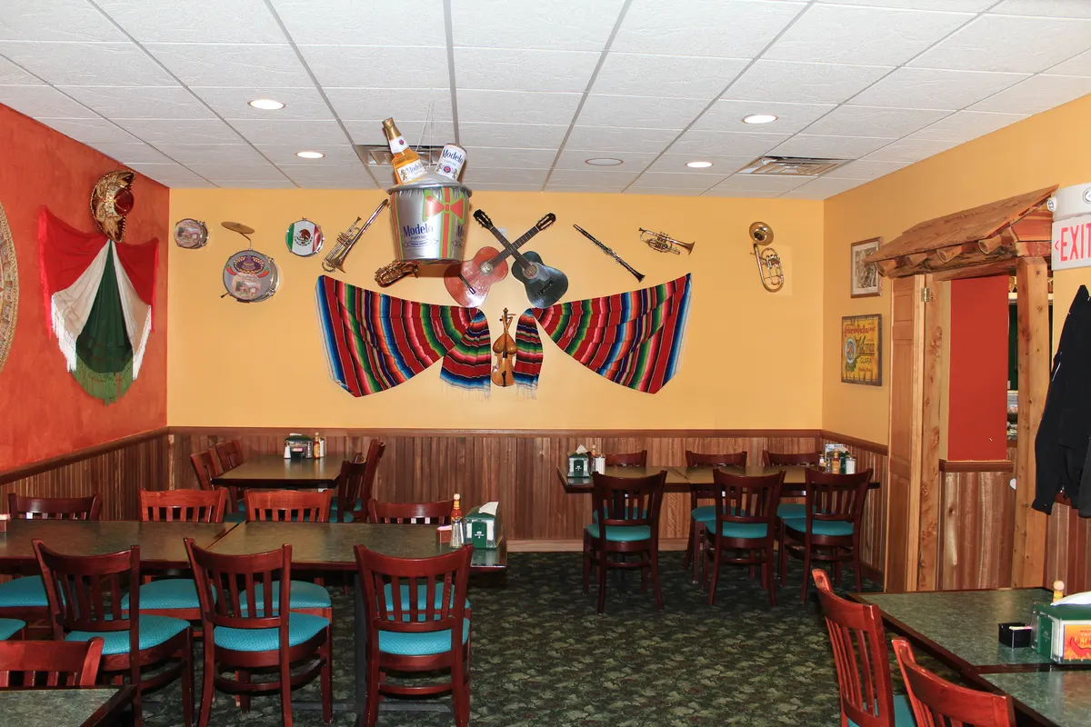 The dining room with wooden tables, Mexican flags and colorful wall decorations