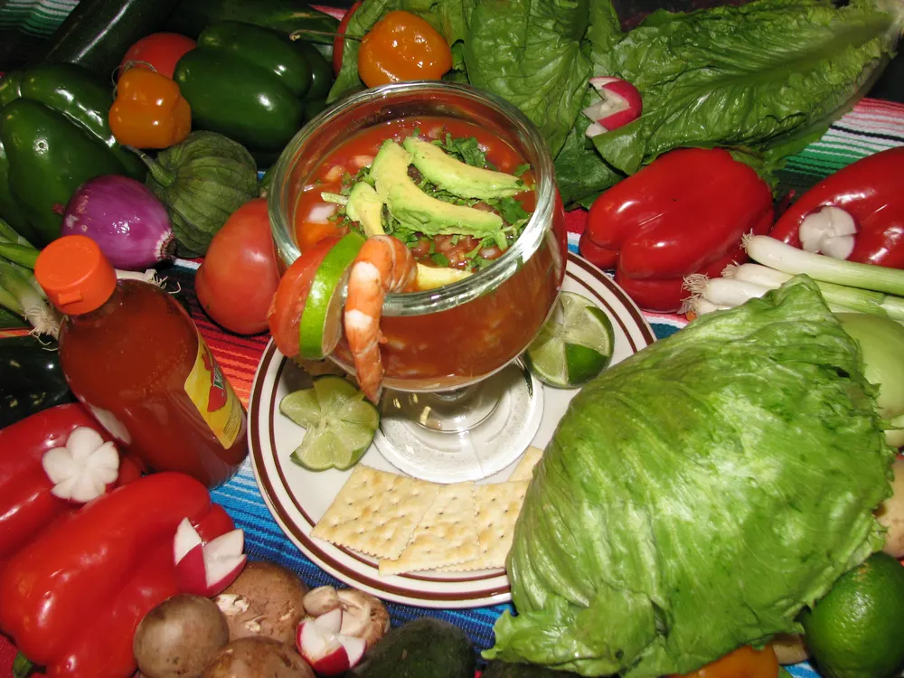 A shrimp cocktail with avocado and lime