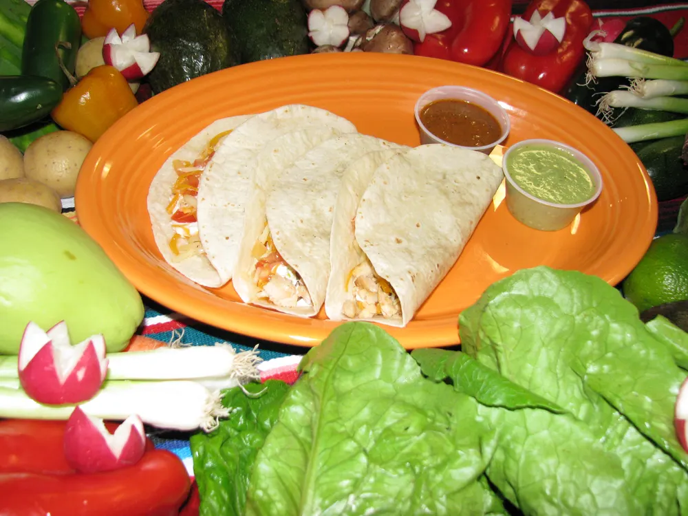 Soft tacos served with salsa